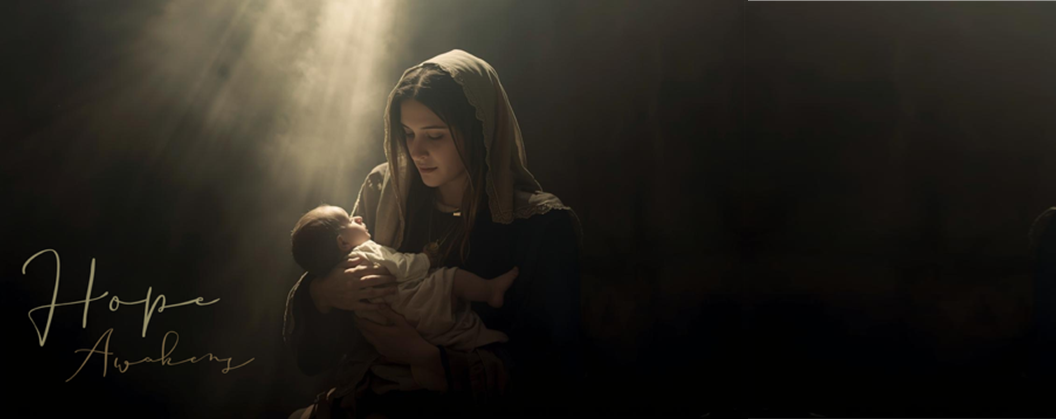 mary cradling the infant child with shaft of light above them